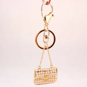 Gold Miniature Handbag Keychain with Faux Pearls 6 S55ed589baea04fe79be75644a3871e3c9