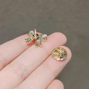 Elegant Gold-Toned Bowknot Brooch with Rhinestones 11 S9bd268b4af6a47c19660a6b055c09a17m