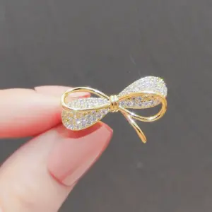Elegant Gold-Toned Bowknot Brooch with Rhinestones 16 Se9229dfd7074403495a97ab5d8143a39k